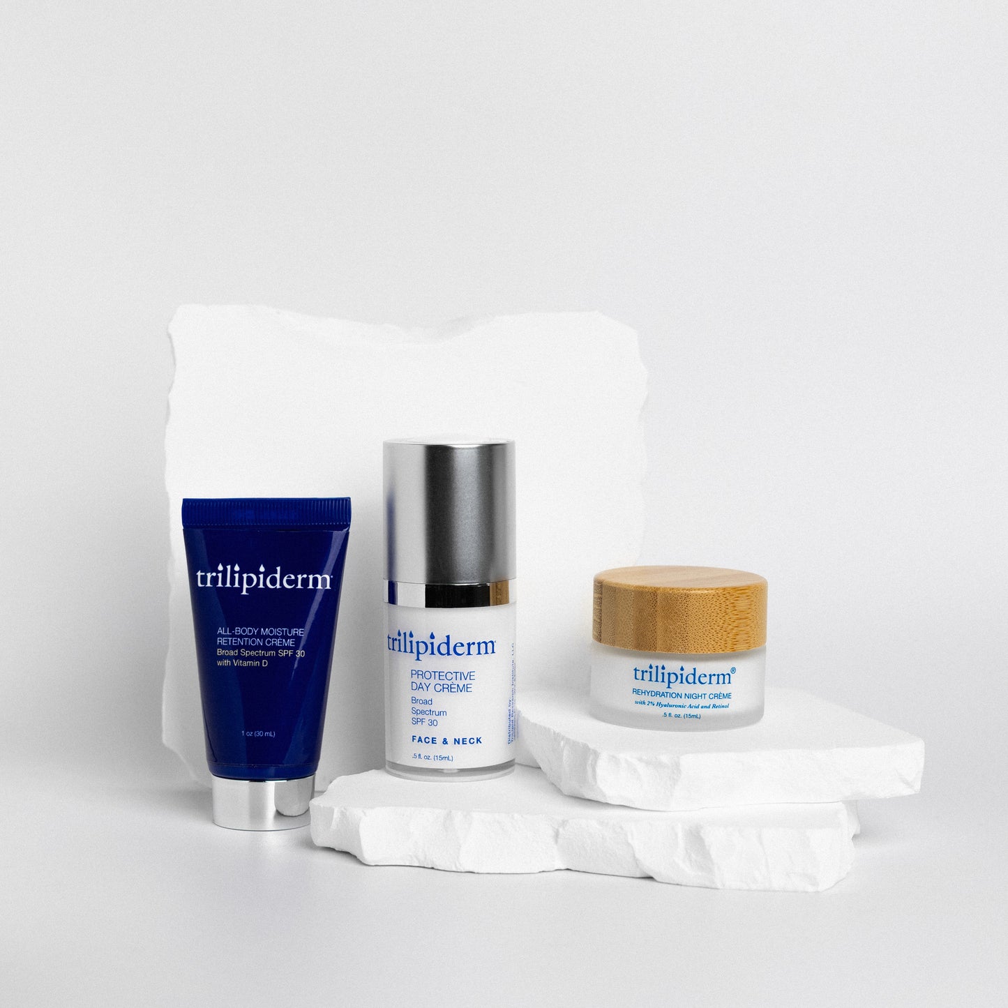 Trillipiderm skincare products on a white background on white rock
