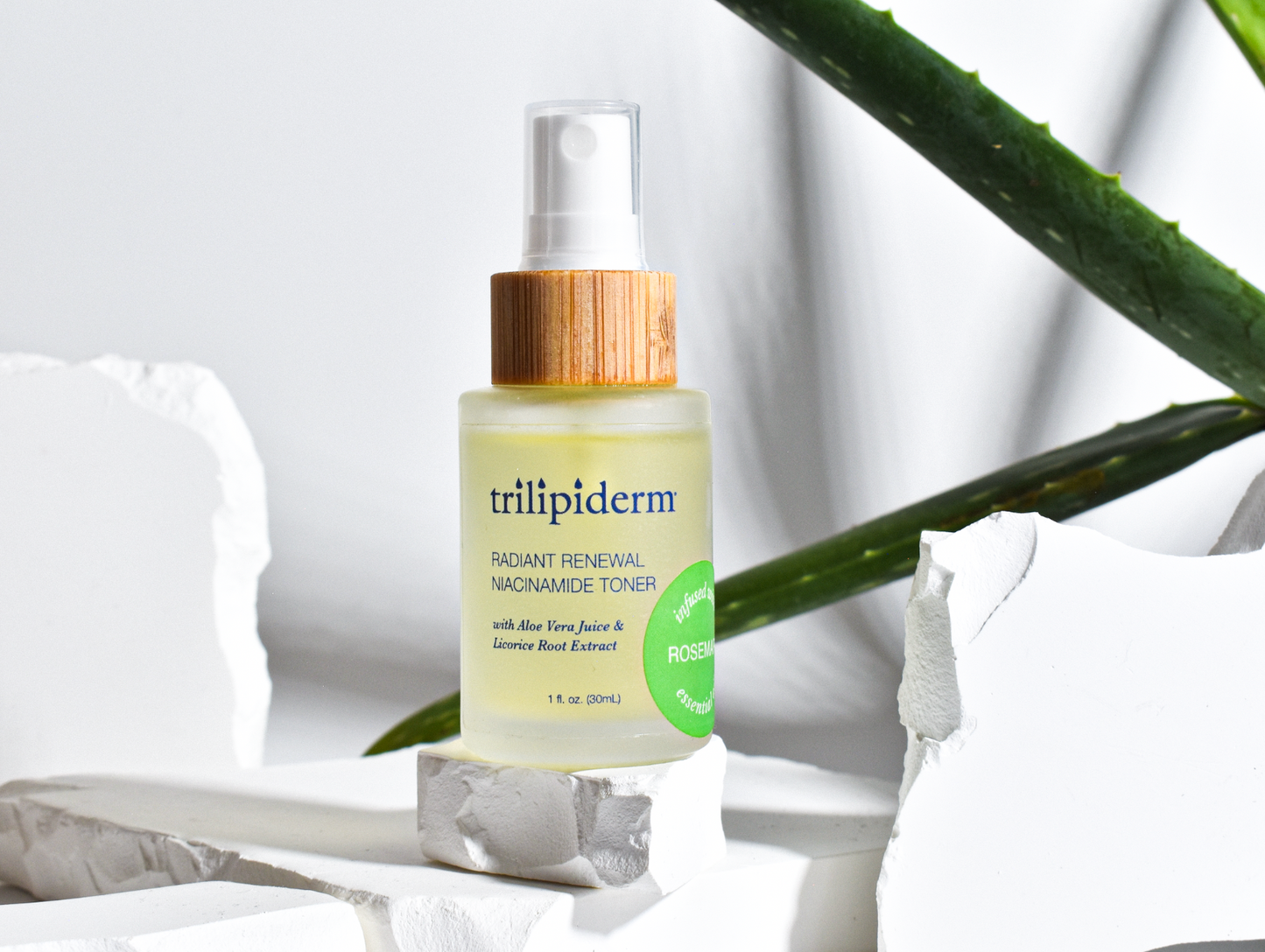 A bottle of Trilipiderm Radiant Renewal Niacinamide Toner with a yellowish liquid visible through the clear container and a bamboo cap.