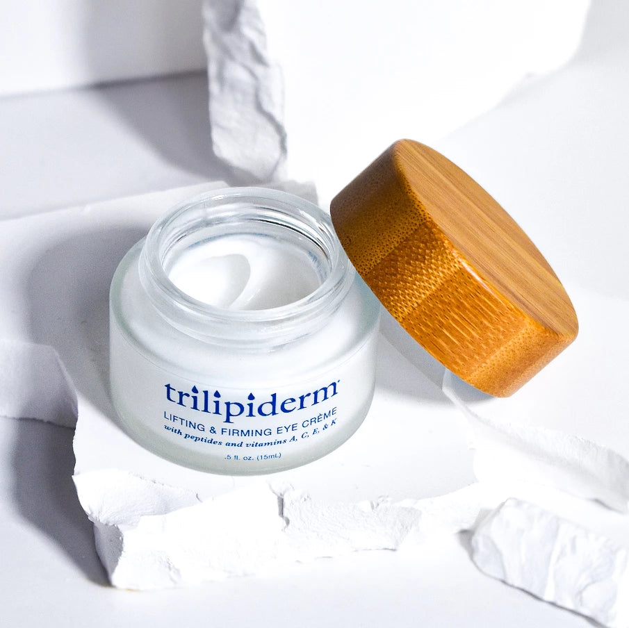 trilipiderm eye creme with bamboo cap displayed on white rock