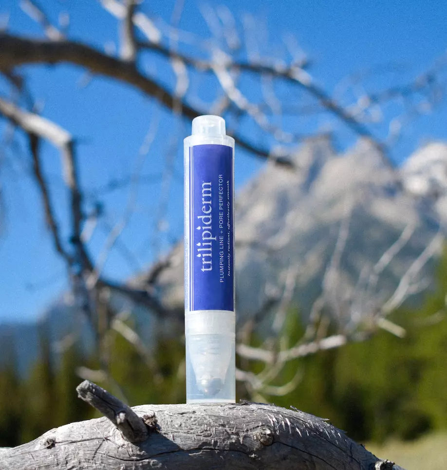 trilipiderm product displayed in nature with trees blurred in background