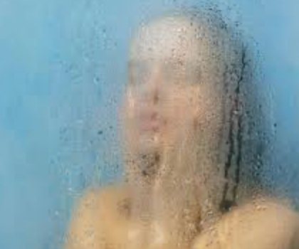 Steamy hot shower illustrating how excessive heat can strip natural oils, weaken the skin barrier, and lead to extremely dry skin.