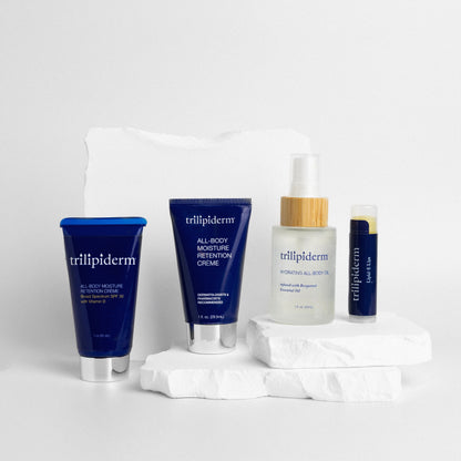 Trillipiderm skincare products on a white background and white rock