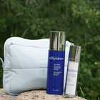 Two skincare products from trilipiderm on a rock with a green natural background