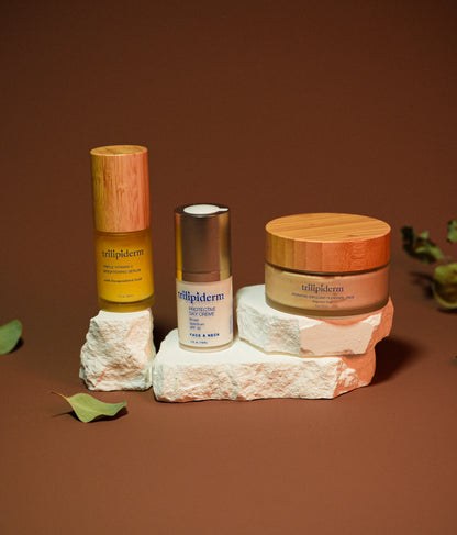 Three skincare products from the brand 'tellipiderm' on a textured surface with a brown background.