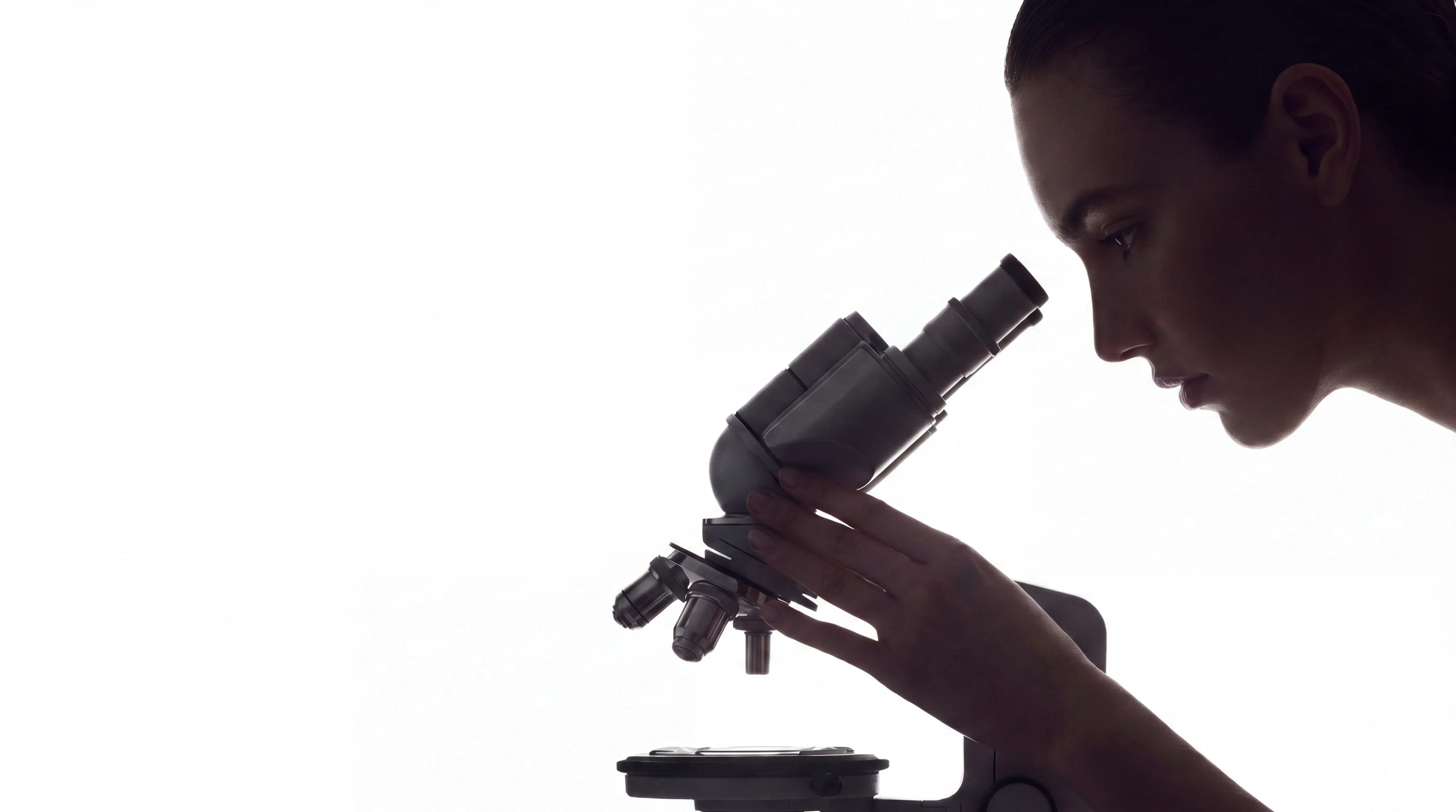 Lage looking through a microscope