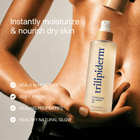 A person holds a bottle of trilipiderm Hydrating All-Body Oil against their torso, with Trilipiderm Hydrating All-Body Oil with bamboo cap, highlighting moisture retention, nourishment for dry skin, a silky finish, and a healthy, radiant glow.