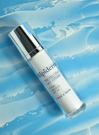 trilipiderm day creme laying down with silver top against a blue gradient background