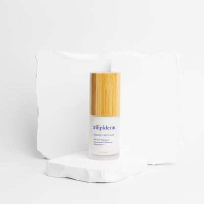 age defy neck lift with glass bottle and bamboo top displayed on white rock
