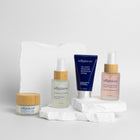 Trillipiderm skincare products on a white background and white rock