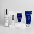 Trillipiderm skincare products on a light gray background and white rock
