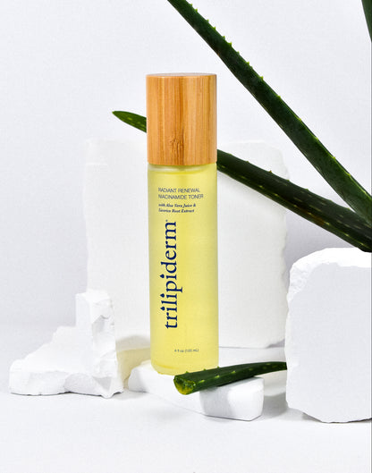 A bottle of Trilipiderm Radiant Renewal Niacinamide Toner with a yellowish liquid visible through the clear container and a bamboo cap.