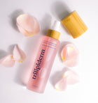 Trilipiderm Youthful Rosehip Toning Elixir ingredient infographic featuring frosted pink glass toner bottle with bamboo cap and translucent rose spheres on white background. Key ingredients include Vitamins C + A, rosehip extract, antioxidant complex, hydrating humectants, and soothing botanical agents. Hydrating facial mist toner designed for barrier repair, collagen support, and antioxidant protection for all skin types including sensitive.