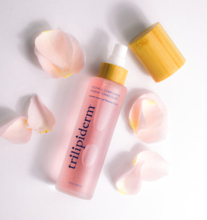 Trilipiderm Youthful Rosehip Toning Elixir ingredient infographic featuring frosted pink glass toner bottle with bamboo cap and translucent rose spheres on white background. Key ingredients include Vitamins C + A, rosehip extract, antioxidant complex, hydrating humectants, and soothing botanical agents. Hydrating facial mist toner designed for barrier repair, collagen support, and antioxidant protection for all skin types including sensitive.
