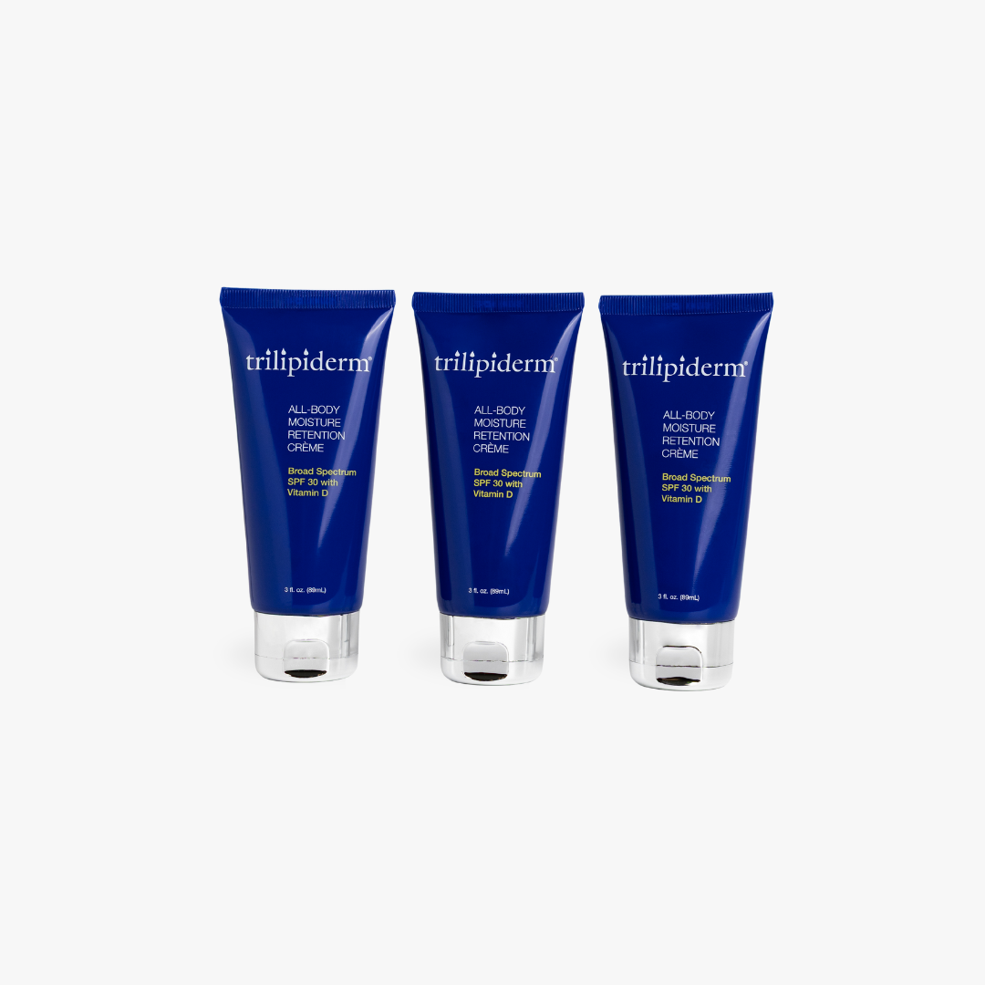 Three bottles of trillipiderm All Body Moisture Repair Creme on a white background