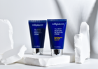 two tubes of trilipiderm lotion displayed on white rock with white background