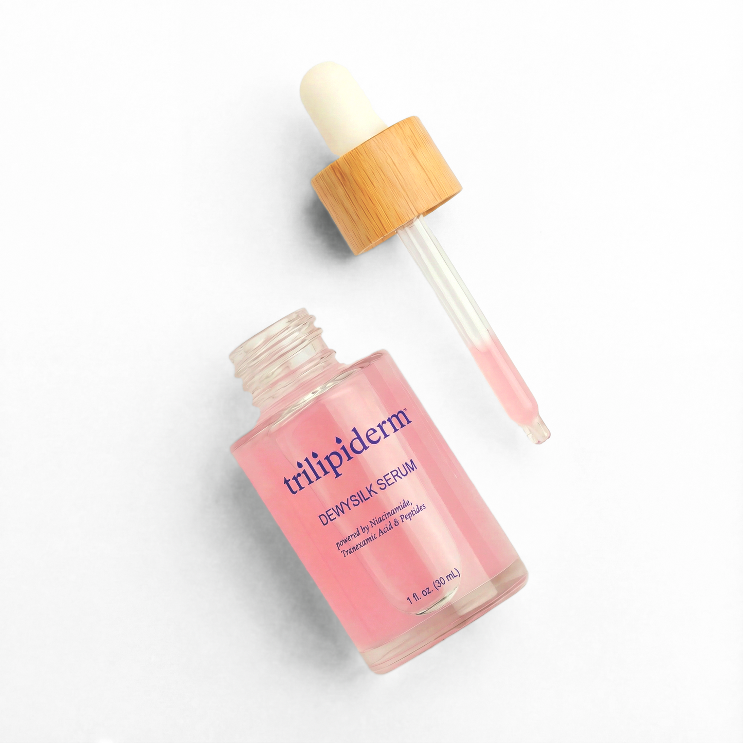 Trilipiderm DewySilk Serum with glass dropper on white background featuring niacinamide, tranexamic acid, and peptides for brightening, dark spot correction, hydration, and glass skin glow. Lightweight pink facial serum in frosted glass bottle designed to improve skin texture, support barrier repair, and enhance radiance for all skin types including sensitive skin.