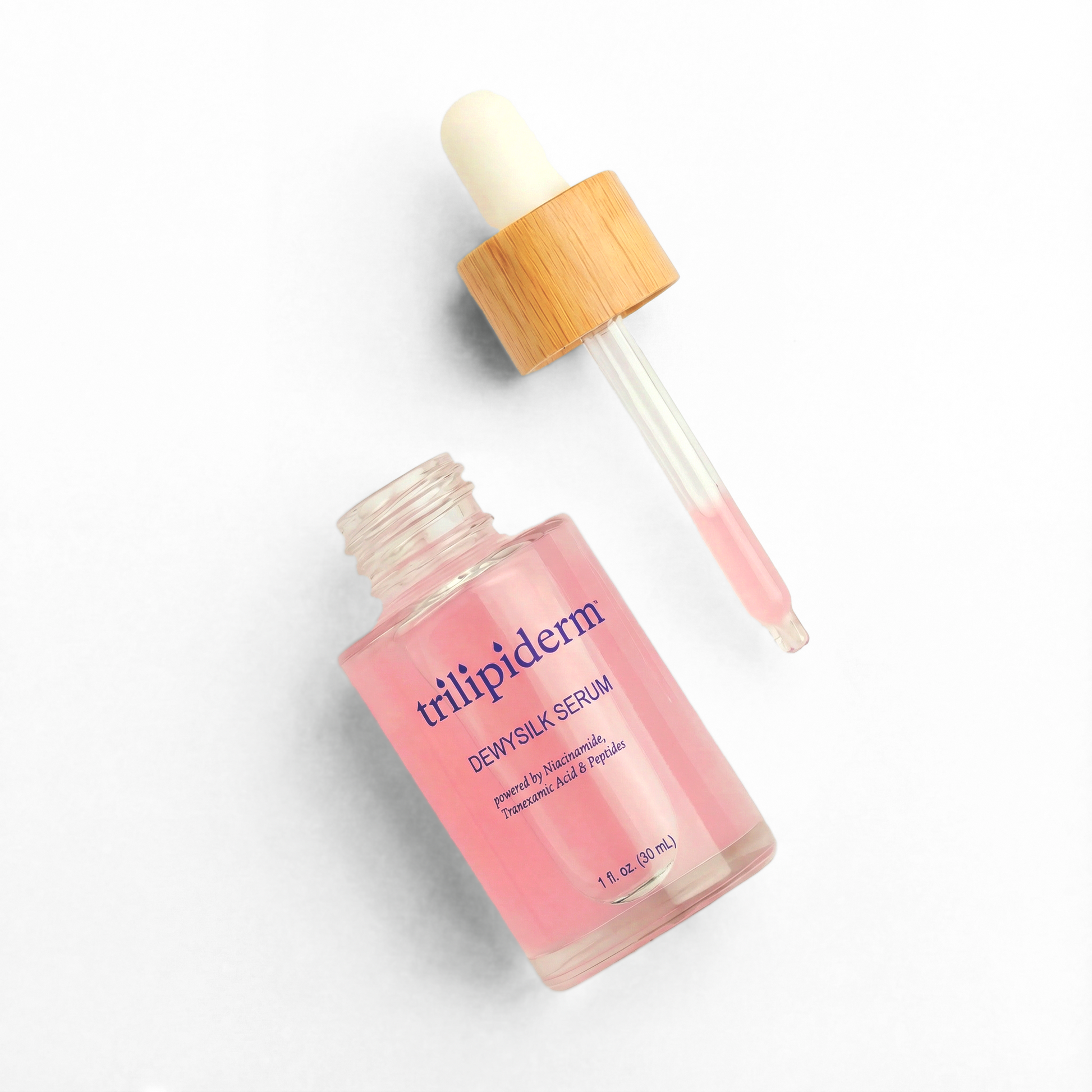 Trilipiderm DewySilk Serum with glass dropper on white background featuring niacinamide, tranexamic acid, and peptides for brightening, dark spot correction, hydration, and glass skin glow. Lightweight pink facial serum in frosted glass bottle designed to improve skin texture, support barrier repair, and enhance radiance for all skin types including sensitive skin.