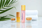 Trilipiderm skincare products on a marble surface with green leaves in the background