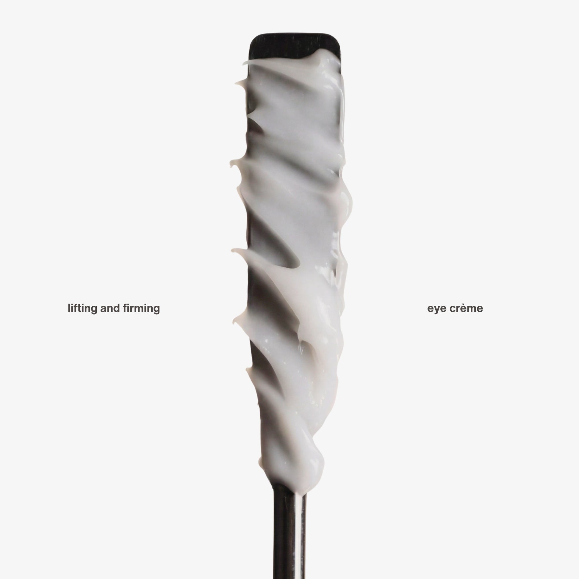 Cosmetic applicator with white lifting and firming eye cream on a white background. Lifting and firming eye crème is a peptide anti-aging eye cream for all skin types, with hydrating and anti-aging benefits.
