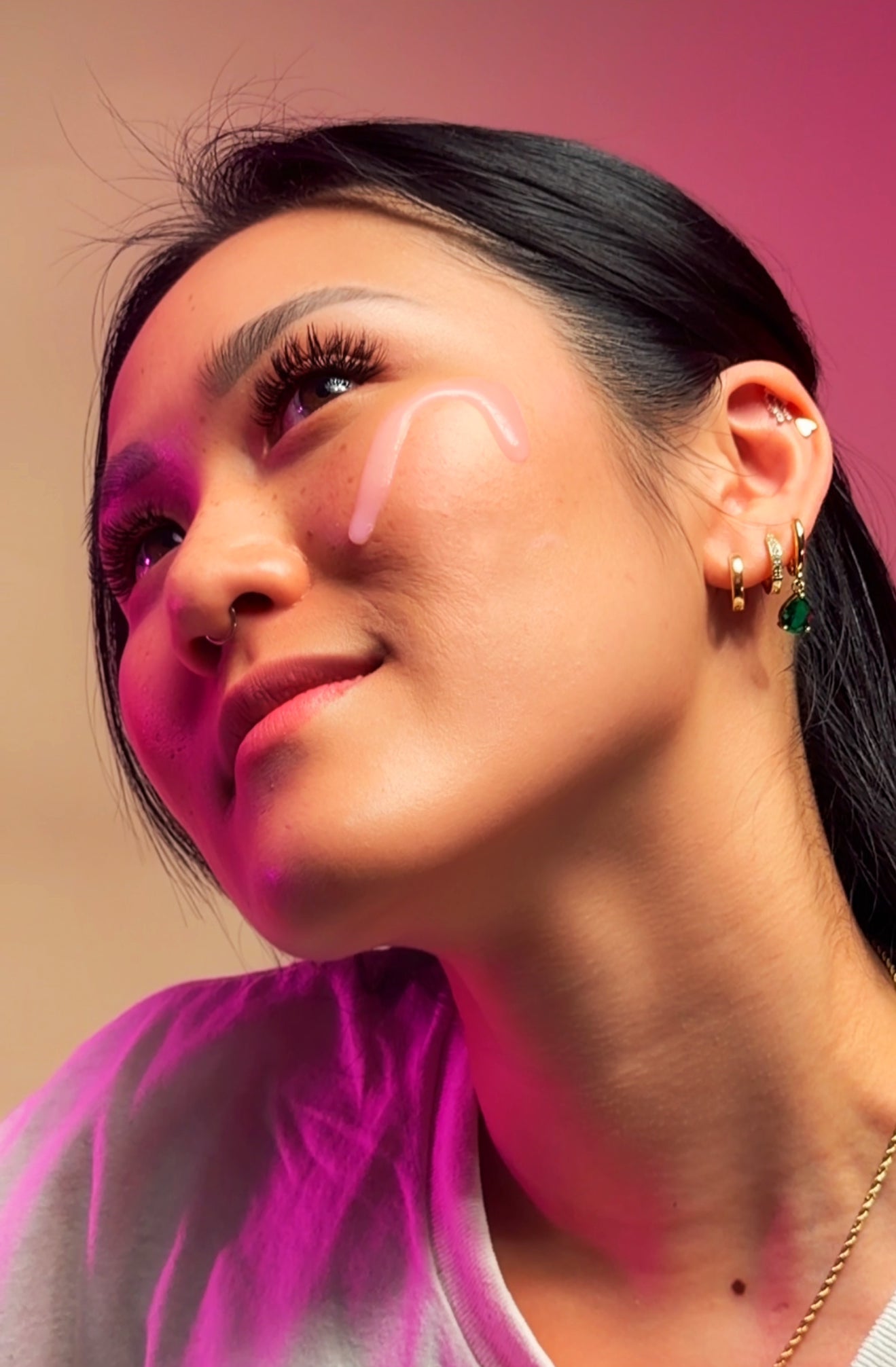 model with dewy silk serum on skin smiling
