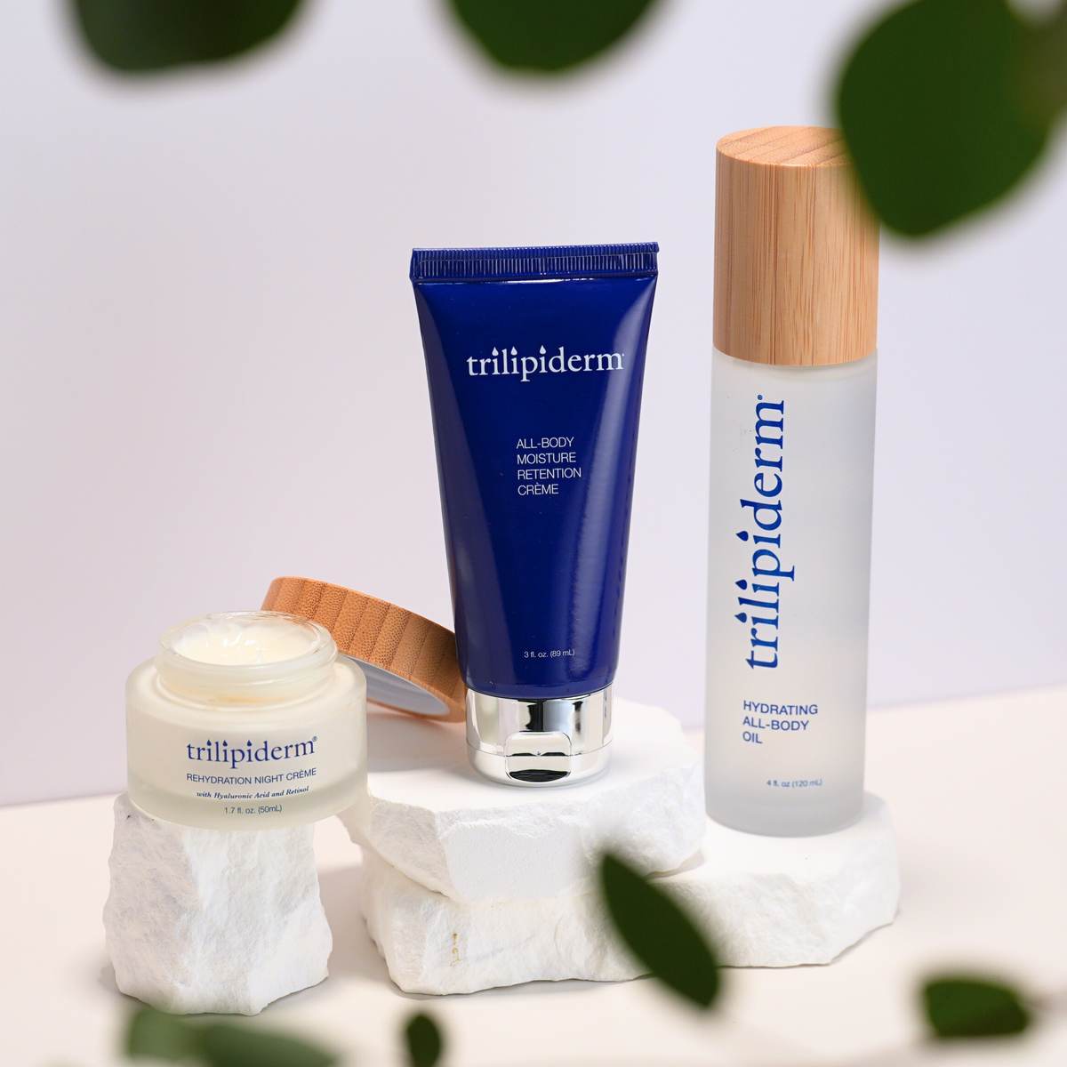 Trilipiderm Barrier Rescue Trio featuring Hydrating All-Body Oil, All-Body Moisture Retention Crème, and Rehydration Night Crème for barrier support, deep hydration, and moisture retention.