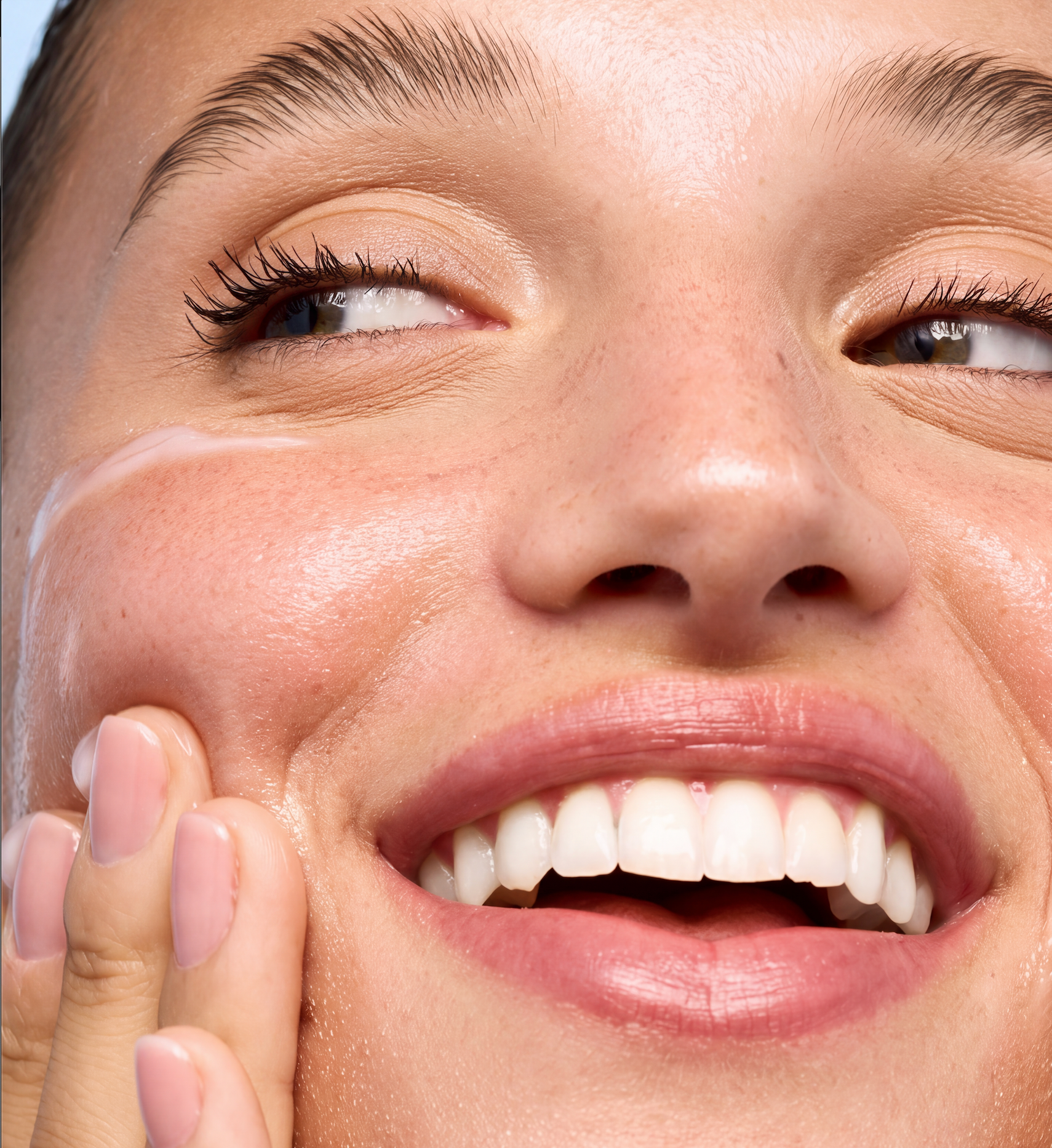 Woman applying Trilipiderm barrier repair skincare to her face, featuring lipid botanical skincare formulated to moisturize, support the skin barrier, and promote healthy-looking hydrated skin.