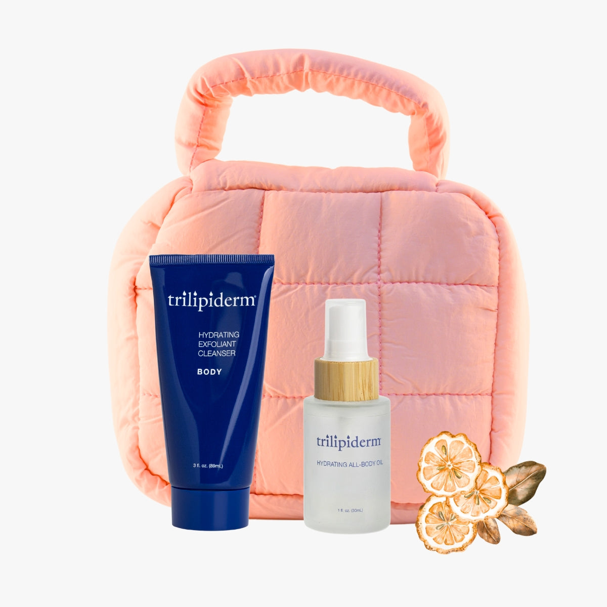 Trilipiderm Bergamot Essence Duo with citrus-infused body oil and exfoliating cleanser in coral puffer pouch, luxury brightening holiday skincare set.