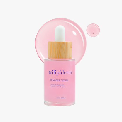 Pink serum bottle with wooden dropper labeled 'trillipiderm' on a white background with pink serum swatch. Dewy Silk Serum featuring niacinamide, Tranexamic acid, and hyaluronic acidhis powerhouse face serum is deeply hydrating, leaving skin glowing, bouncy, and dewy. Perfect serum to achieve glass skin.