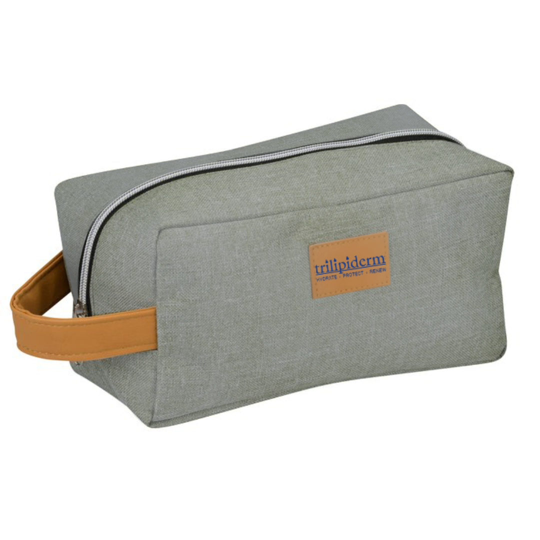 Trilipiderm Heather Gray Dopp Kit with tan leather handle and zipper closure — luxury travel toiletry bag for skincare essentials.