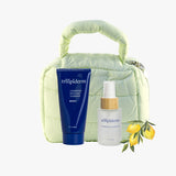 Trilipiderm Lemongrass Essence Duo with Hydrating All-Body Oil and Exfoliating Cleanser in a soft green puffer pouch, refreshing natural skincare gift set
