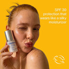 A woman with freckles holds a bottle of trilipiderms Protecting Sun Serum against a bright yellow background, with text on the right reading 'SPF 30 protection that wears like a silky moisturizer' and a cruelty free leaping bunny logo at the bottom right.