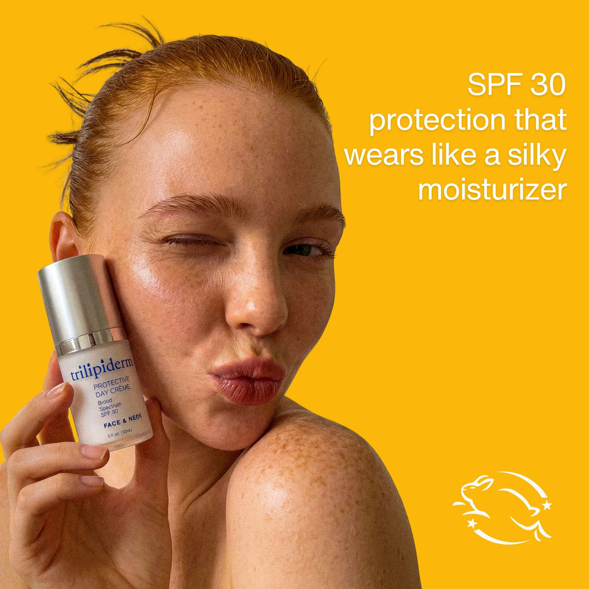 A woman with freckles holds a bottle of trilipiderms Protecting Sun Serum against a bright yellow background, with text on the right reading 'SPF 30 protection that wears like a silky moisturizer' and a cruelty free leaping bunny logo at the bottom right.