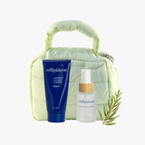 Trilipiderm Lemongrass Essence Duo with Hydrating All-Body Oil and Exfoliating Cleanser in a soft green puffer pouch, refreshing natural skincare gift set.