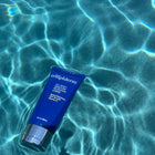 all body moisture cream spf 30 floating in vibrant blue water