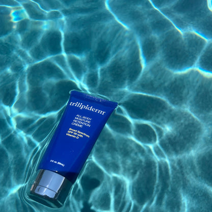 all body moisture cream spf 30 floating in vibrant blue water